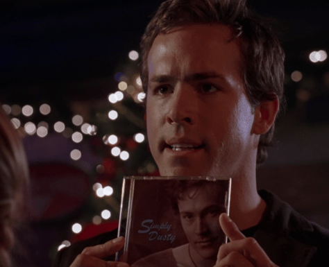 Chris Brander (Ryan Reynolds) holding the "Simply Dusty" album by Dusty "Lee" Dinkleman (Chris Klein)
